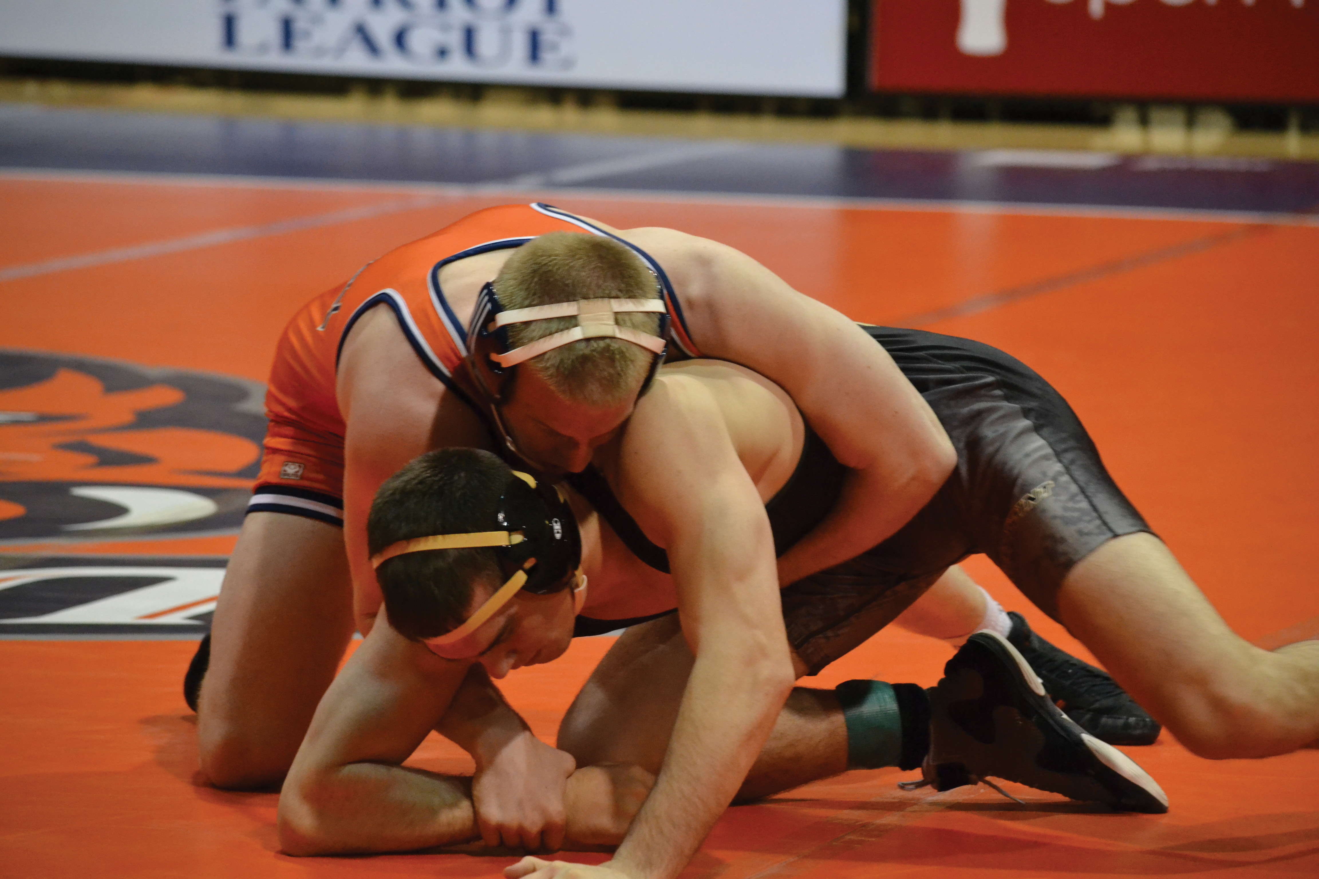 Estie Pyper | The Bucknellian Stephen McPeek '14 tries to pin his opponent in one of the wrestling team's recent matches. The Bison defeated George Mason 21-12 in their home match last Saturday.