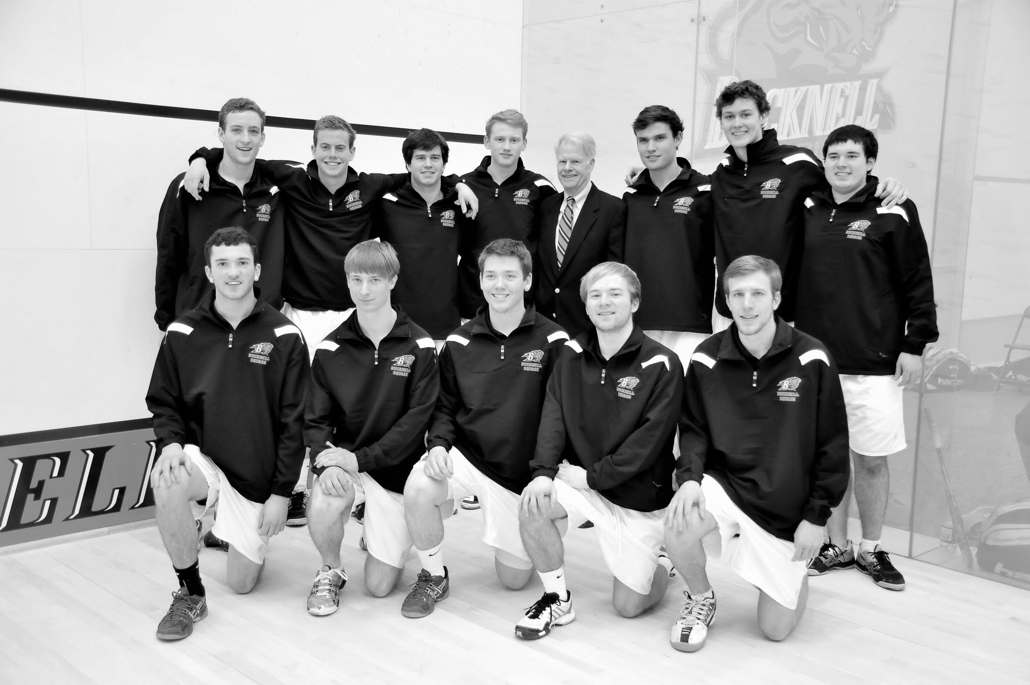 Xiaolong Li | The Bucknellian The men's squash team poses with Frank Wiegand '60 in the new squash court. Coming off their Patriot League Tournament victory, the Bison won all four of their matches on Saturday.